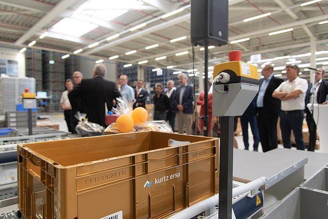 The first container is stored in the automatic warehouse